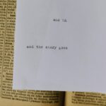 A piece of paper with typewritten text 'and the story goes' over an old book page.